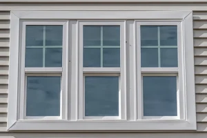 Closeup of triple hung vinyl windows on a house