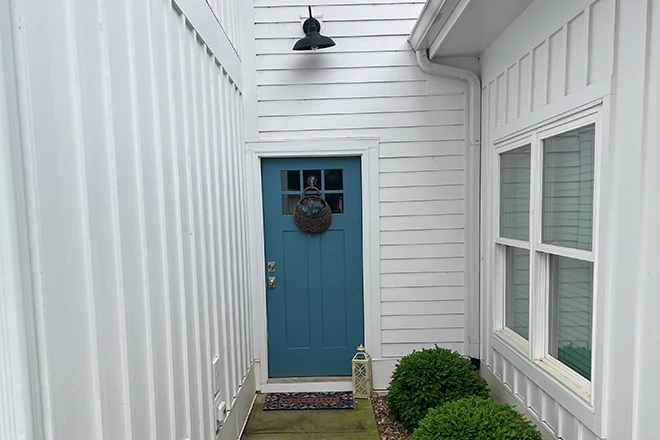 White Hardie Plank siding and a blue door