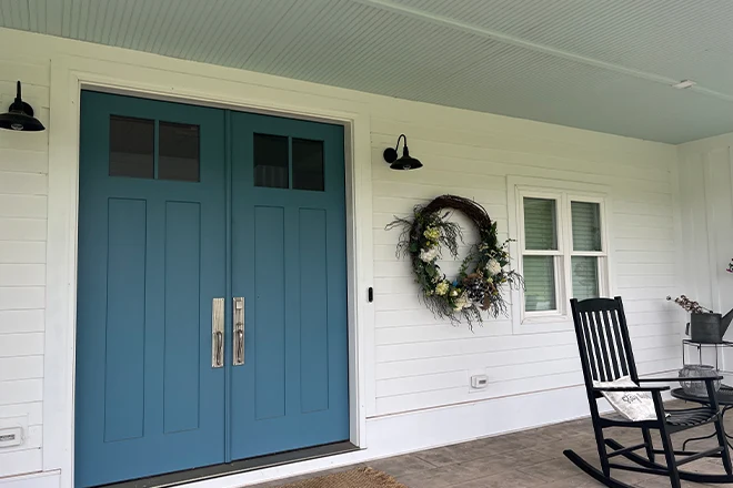 White James Hardie siding front entrance with blue double doors