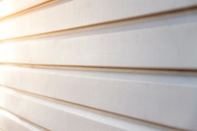 Closeup of off-white vinyl siding on home
