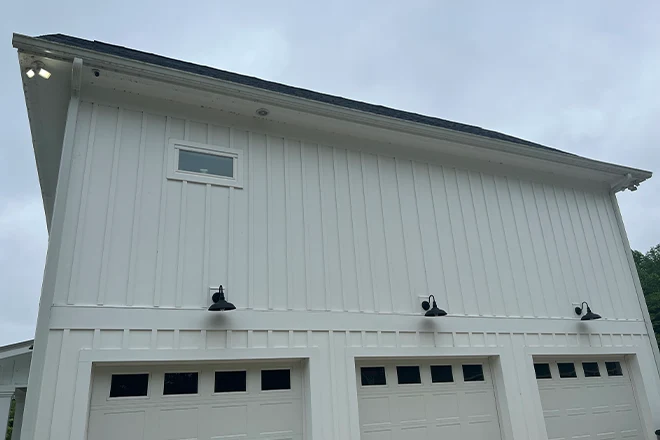 White Hardie Plank siding on a home above a 3 door garage