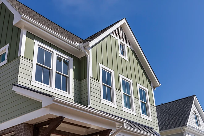 Home with light-green siding that is both vertical and horizontal