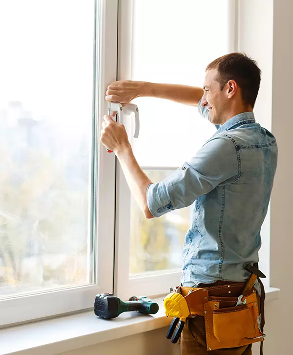 Man Performing Window Installation In Huntsville Home