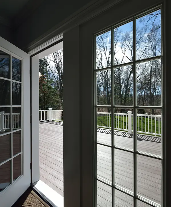 Garden deck view through the window glass. French door opening to a large deck.